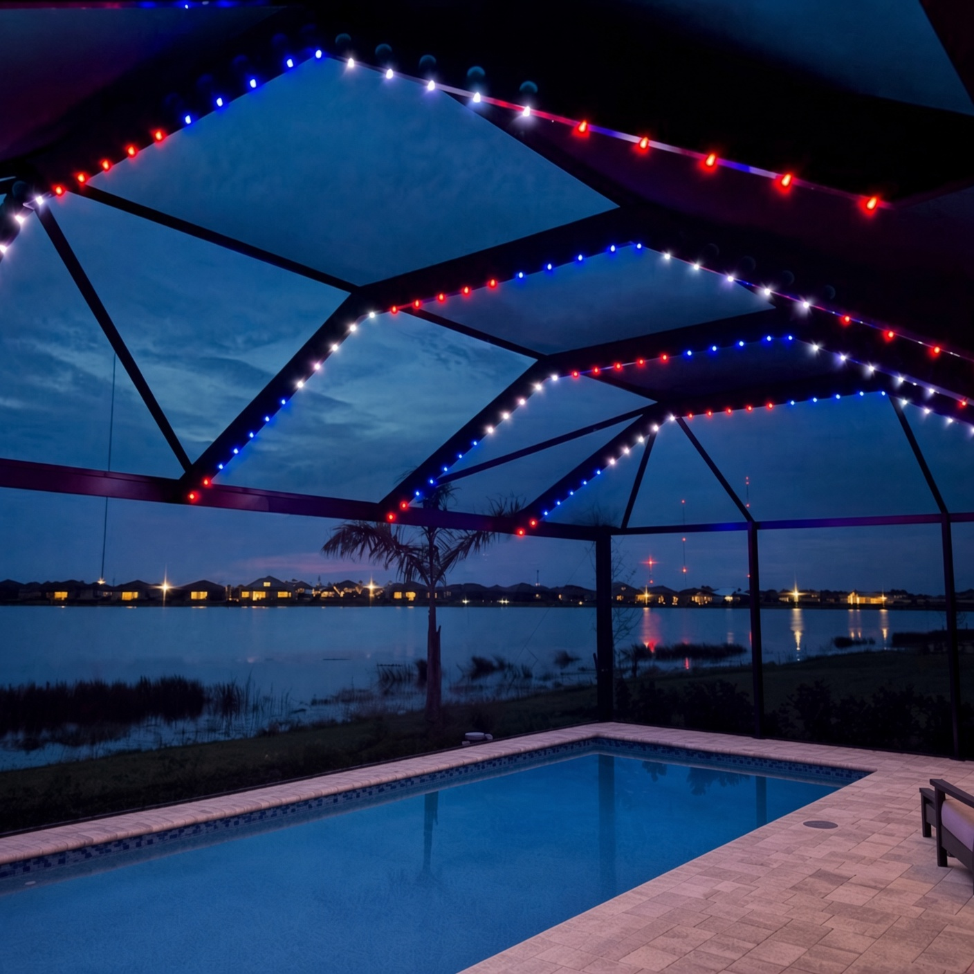 Holiday color scenes on a pool cage with permanent puck lighting