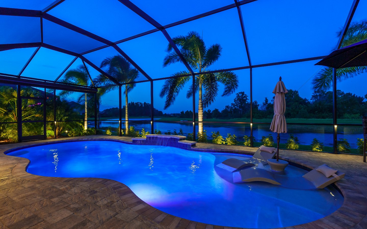 Finished Clearwater pool cage with permanent puck lighting on the large beams