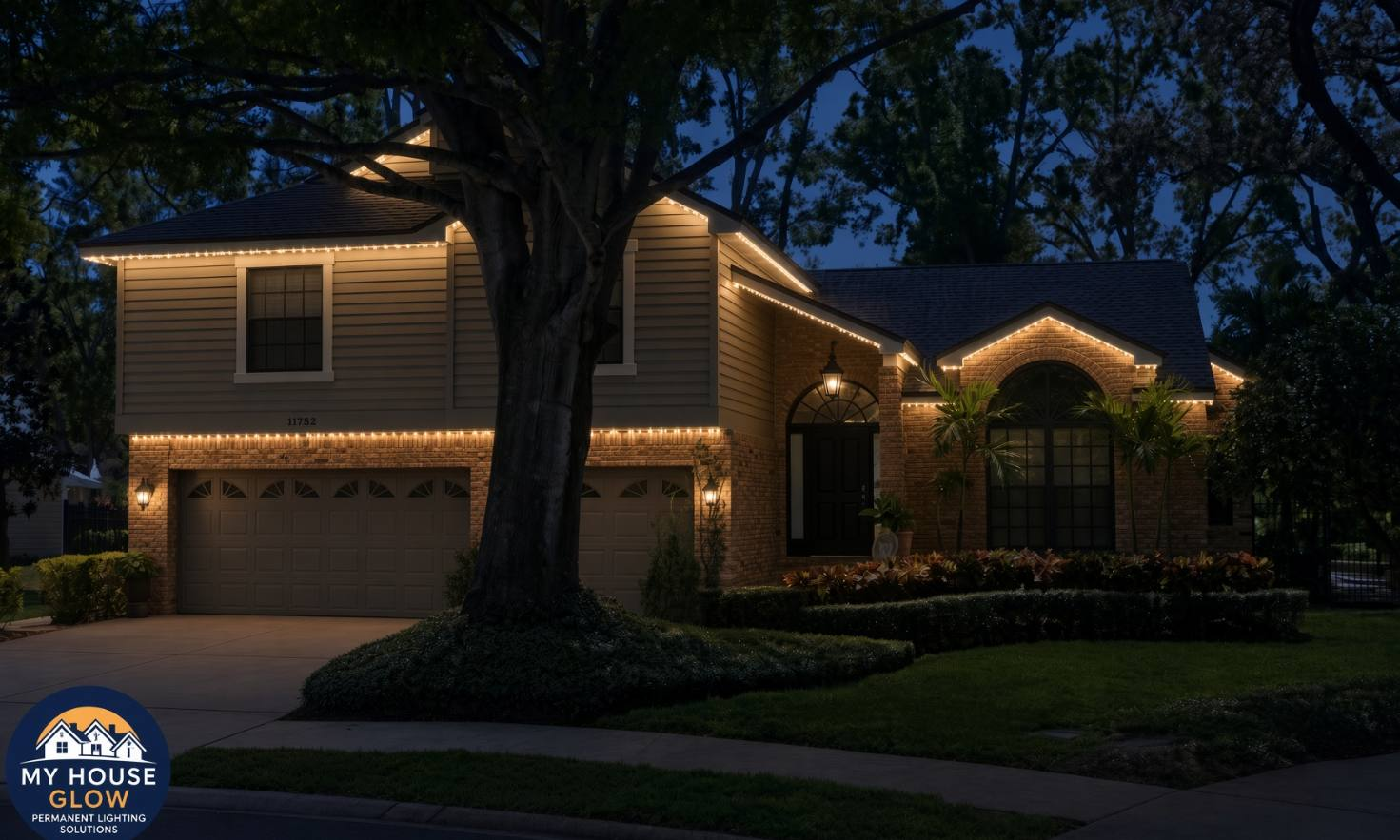 The same house with permanent warm-white lights on the roofline at night